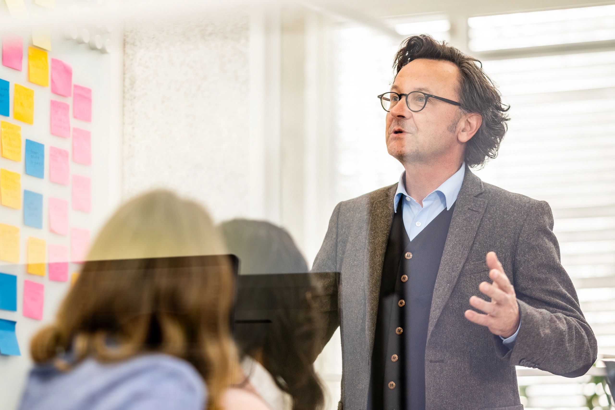 Business coach leading a workshop for professionals in a conference room