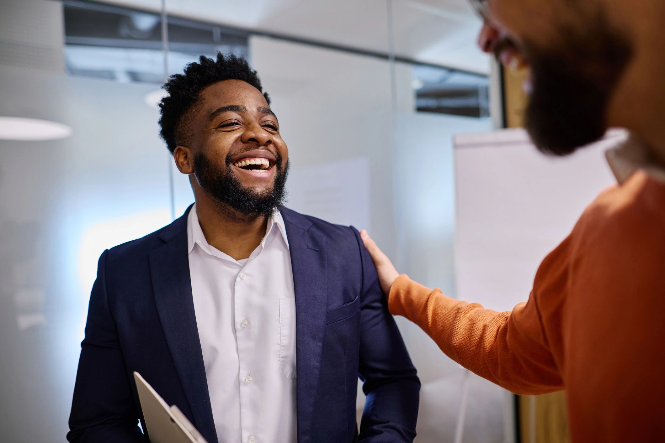 Manager congratulating an employee in an office