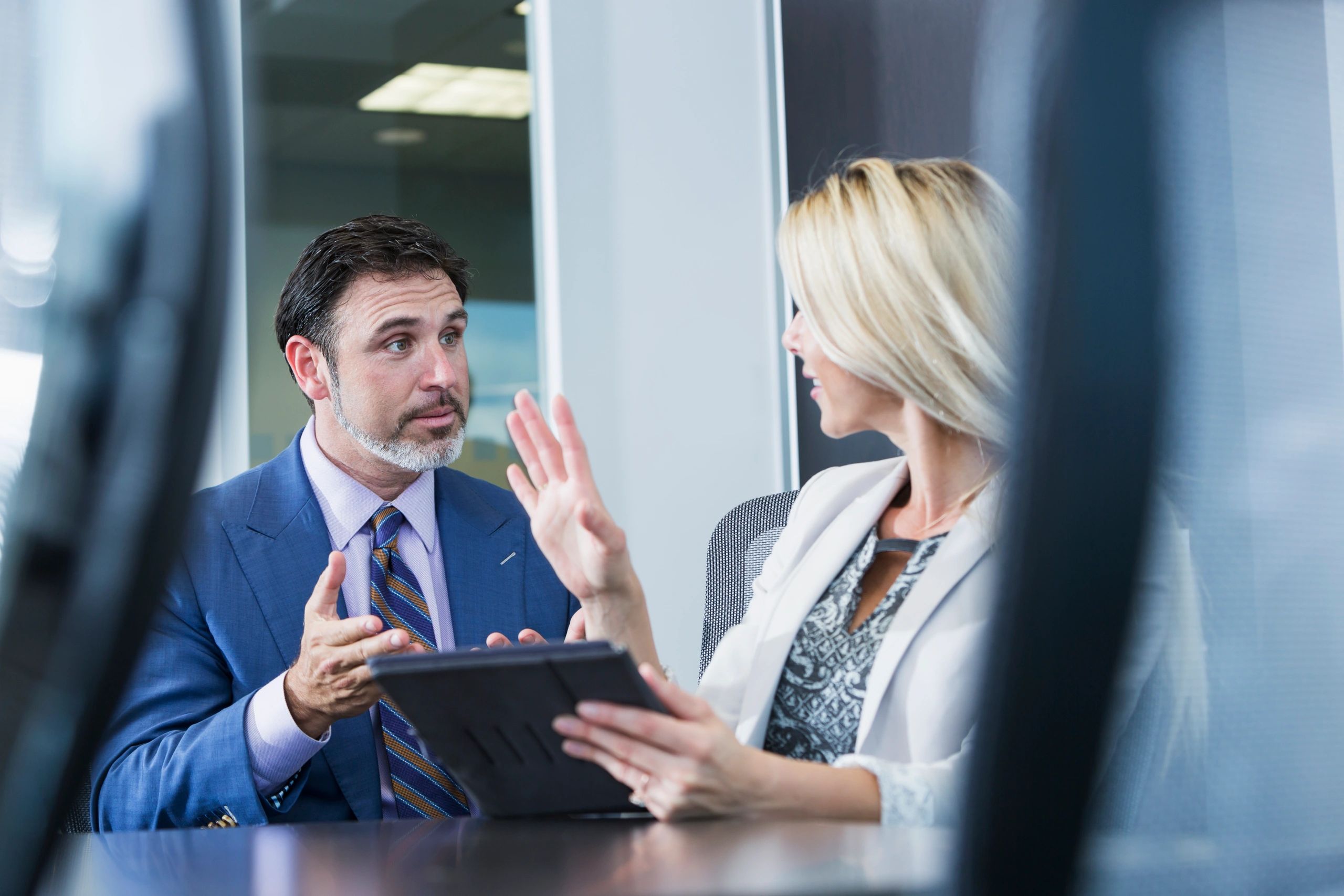 Professional in a meeting using a digital tablet